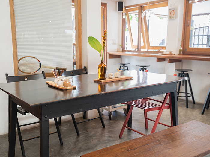 Interior of wooden table and chairs with foliage decoration
