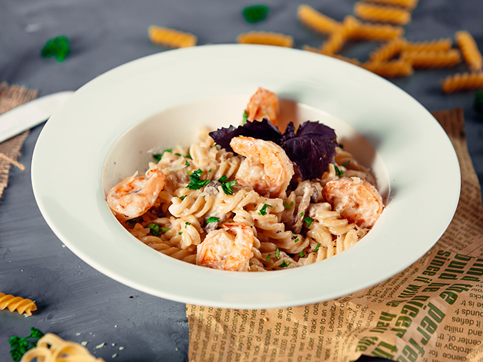 creamy fusilli pasta with fried shrimps and fresh herbs
