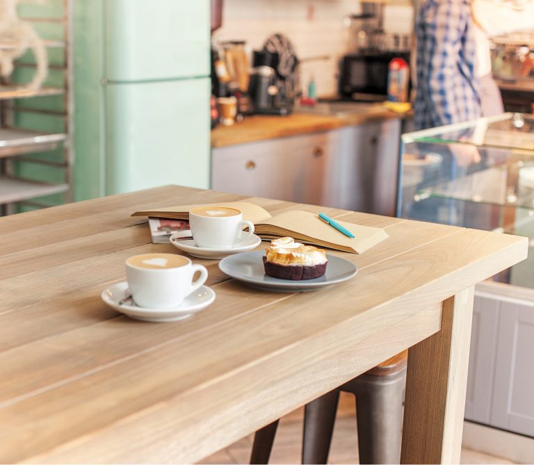 A table setting for coffee on the counter at a coffee house