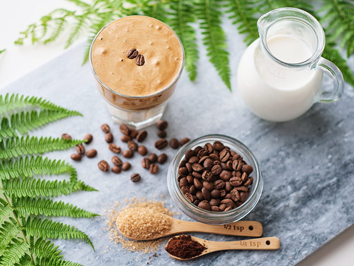 Top view of  dalgona coffee with almond milk and brown sugar, co