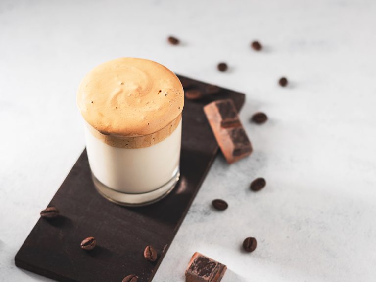 Whipped Dalgona coffee drink in a glass with milk