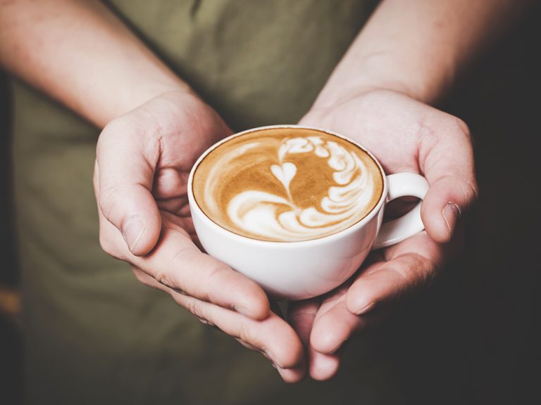 Barista handling Hot Cafe Latte