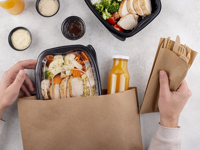 close-up-hands-holding-food-pack-cutlery