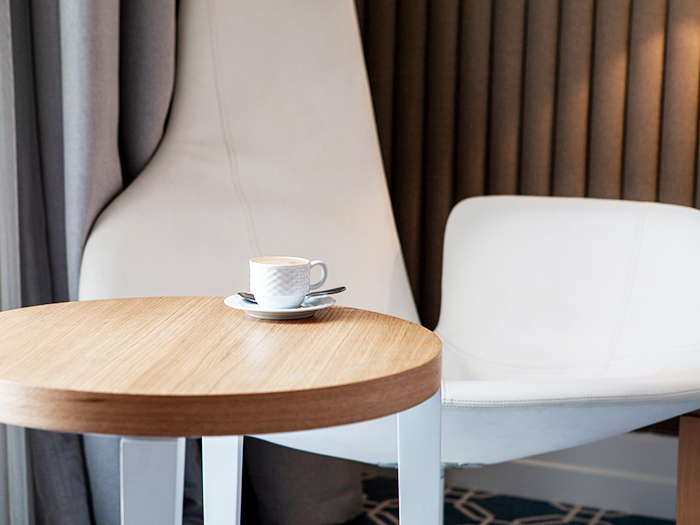 Side view cup of coffee on a small round table horizontal