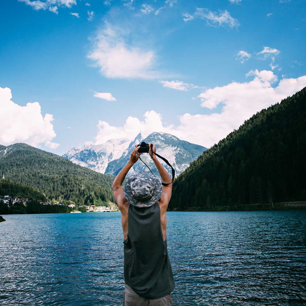 tourist-taking-photos-nature-landscape-using-his-smartphone