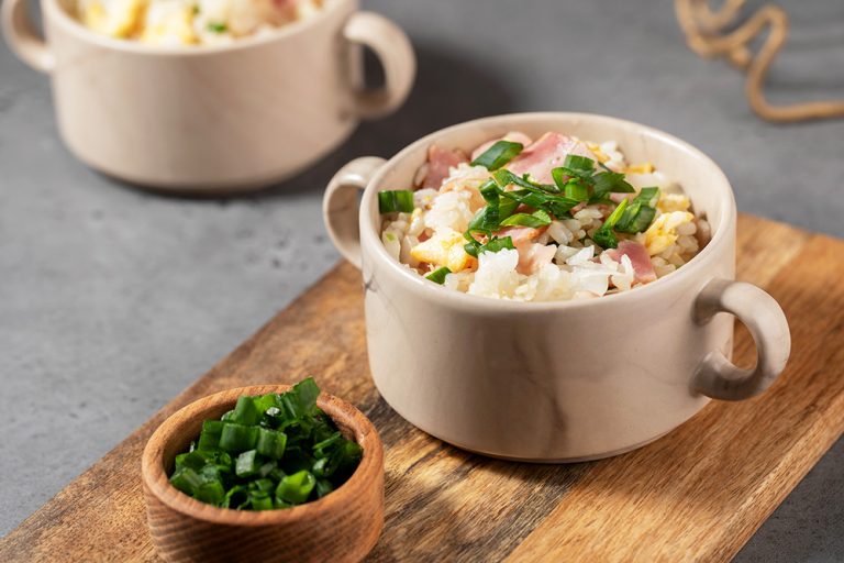 Fried rice with bacon and egg. Asian rice dish. Copy space