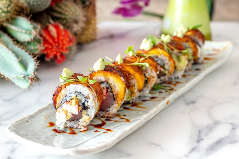 Plate of tasty crab and salmon sushi rolls