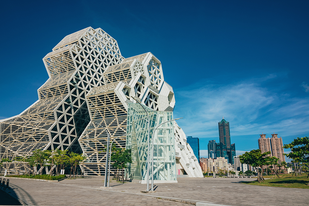 Kaohsiung, Taiwan- May 8, 2021: Kaohsiung Music Center with the view from Love River. The white hexagonal building structure on the riverbank in Kaohsiung, Taiwan