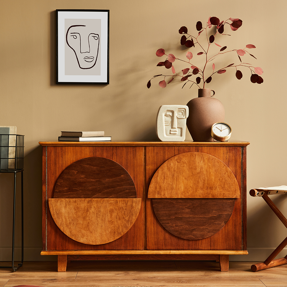 Stylish interior with design wooden commode, stool, dried flower